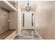 Bright entryway showcasing hardwood floors, a modern chandelier, and custom built-in bench at 5995 Se 22Nd Ave, Ocala, FL 34480