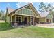 Charming home featuring a cozy front porch with rocking chairs and stone-accented columns at 5995 Se 22Nd Ave, Ocala, FL 34480