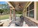 Inviting covered porch with stone pillars, ceiling fans, and ample space for relaxing seating at 5995 Se 22Nd Ave, Ocala, FL 34480