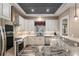 An inviting kitchen featuring granite countertops, stainless steel appliances, and a stylish wood-paneled ceiling at 5995 Se 22Nd Ave, Ocala, FL 34480