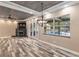 Spacious living room showcasing French doors to the pool and a striking wood-paneled ceiling at 5995 Se 22Nd Ave, Ocala, FL 34480