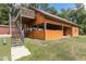 The outbuilding features a deck and an open area, providing a versatile space for outdoor activities and entertainment at 5995 Se 22Nd Ave, Ocala, FL 34480