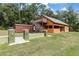 Exterior view of the outbuilding featuring a deck, stairs, and a shed offering additional storage space at 5995 Se 22Nd Ave, Ocala, FL 34480