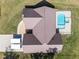 Aerial view of the roof with in-ground pool and concrete driveway leading up to the home at 5995 Se 22Nd Ave, Ocala, FL 34480