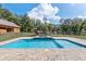 Sparkling in-ground pool with a brick paver surround, spa and a fenced yard at 5995 Se 22Nd Ave, Ocala, FL 34480