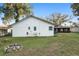 The back of the house overlooks a spacious, grassy yard with mature trees at 711 Se 26Th St, Ocala, FL 34471