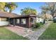 Backyard view featuring a patio, mature trees and walkway at 711 Se 26Th St, Ocala, FL 34471