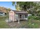 Backyard featuring a chicken coop, wooden accents, and a fenced enclosure at 711 Se 26Th St, Ocala, FL 34471