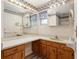 Bathroom features light wood cabinetry and a long white countertop with vintage-inspired wallpaper at 711 Se 26Th St, Ocala, FL 34471