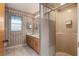 Bathroom with double vanity, shower and neutral patterned wallpaper at 711 Se 26Th St, Ocala, FL 34471