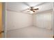 Spacious bedroom with neutral carpet, ceiling fan and natural light at 711 Se 26Th St, Ocala, FL 34471