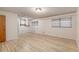 Spacious bedroom featuring wood plank floors, ceiling fan, natural light, and neutral walls at 711 Se 26Th St, Ocala, FL 34471