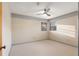 Bright bedroom with neutral carpet, ceiling fan and natural light at 711 Se 26Th St, Ocala, FL 34471