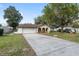 Inviting home with a long driveway, lush lawn, arched entryways and a two-car garage at 711 Se 26Th St, Ocala, FL 34471