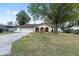 Charming home featuring a well-manicured lawn and an attached garage at 711 Se 26Th St, Ocala, FL 34471