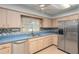 A kitchen featuring stainless steel appliances, blonde wood cabinets, and blue countertops at 711 Se 26Th St, Ocala, FL 34471