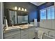 Elegant bathroom featuring double vanity, granite countertop, and a soaking tub with plantation shutters at 8135 Nw 26Th Lane Rd, Ocala, FL 34482