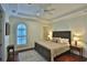 Serene bedroom with a tray ceiling, hardwood floors, and ample natural light at 8135 Nw 26Th Lane Rd, Ocala, FL 34482