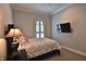 Bedroom featuring a comfortable bed, wall mounted TV and an arched window with shutters at 8135 Nw 26Th Lane Rd, Ocala, FL 34482