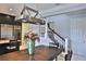 Dining room with a modern light fixture adjacent to the kitchen, wine refrigerator, and staircase at 8135 Nw 26Th Lane Rd, Ocala, FL 34482