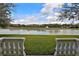 Picturesque view of the tranquil lake from a charming outdoor patio, perfect for relaxing at 8135 Nw 26Th Lane Rd, Ocala, FL 34482