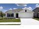 Charming single-story home featuring a two-car garage, well-manicured lawn and a neutral color palette at 8506 Las Palmas Way, Wildwood, FL 34785
