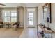 Welcoming entryway featuring a white door with glass, neutral paint, tile floor, and a wooden entry table at 8514 Las Palmas Way, Wildwood, FL 34785