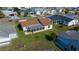 Aerial view of the home showing backyard, screen room, landscaping and nearby neighborhood at 912 Chula Ct, Lady Lake, FL 32159