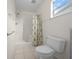 Bathroom featuring a shower with white tile and a floral shower curtain at 912 Chula Ct, Lady Lake, FL 32159