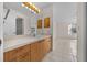 Bathroom with wood vanity, large mirror, and tile flooring at 912 Chula Ct, Lady Lake, FL 32159