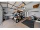 Bright garage with an Ezgo golf cart, utility storage, ceiling fan, and neutral walls at 912 Chula Ct, Lady Lake, FL 32159