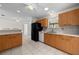 Well-lit kitchen featuring wood cabinets, white appliances, and tile flooring at 912 Chula Ct, Lady Lake, FL 32159