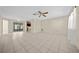 Bright living room featuring tile flooring, a ceiling fan, and access to a screened in porch at 912 Chula Ct, Lady Lake, FL 32159