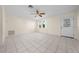 Bright, open living room featuring neutral paint, tile flooring, and fan at 912 Chula Ct, Lady Lake, FL 32159