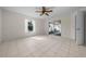 Sunny bedroom featuring tile flooring, a ceiling fan, and sliding glass doors at 912 Chula Ct, Lady Lake, FL 32159