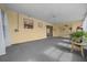 Bright sunroom with carpet flooring, ceiling fan, and sliding glass doors to the backyard at 912 Chula Ct, Lady Lake, FL 32159