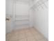 Walk-in closet featuring built-in metal shelving and tile floor at 912 Chula Ct, Lady Lake, FL 32159