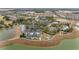 Aerial view featuring a community center with pool, tennis courts, baseball field, and lakeside setting at 9697 Sw 63Rd Loop, Ocala, FL 34481