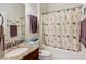 Cozy bathroom featuring a wooden vanity with granite counters and a shower-tub combination at 9697 Sw 63Rd Loop, Ocala, FL 34481