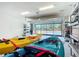 Spacious two car garage with shelving and kayaks for enjoying the nearby waterway at 9697 Sw 63Rd Loop, Ocala, FL 34481