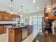 Kitchen features a stainless steel dishwasher and black countertop island with modern pendant lights at 9697 Sw 63Rd Loop, Ocala, FL 34481