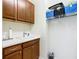 Well-organized laundry room featuring ample storage, a sink, and neutral paint at 9697 Sw 63Rd Loop, Ocala, FL 34481