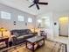 Comfortable living room featuring neutral tones, tile flooring, and ample natural light at 9697 Sw 63Rd Loop, Ocala, FL 34481