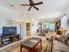 Open-concept living room featuring a ceiling fan, tile floors, and seamless flow to the dining area at 9697 Sw 63Rd Loop, Ocala, FL 34481