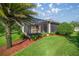 A lush backyard with green grass, landscaping, and a screened-in patio, perfect for outdoor living at 10138 Lake Miona Way, Oxford, FL 34484