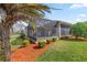 Cozy screened-in porch and manicured lawn provide perfect backyard relaxation at 10138 Lake Miona Way, Oxford, FL 34484