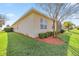 Green backyard with manicured lawn, mature trees, and neat landscaping at 10138 Lake Miona Way, Oxford, FL 34484