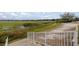 Tranquil backyard featuring lush lakeside views with a safety fence, offering a serene outdoor space at 10138 Lake Miona Way, Oxford, FL 34484