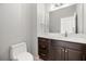 Bathroom featuring dark cabinets, quartz counters, modern fixtures, and a neutral color scheme at 10138 Lake Miona Way, Oxford, FL 34484