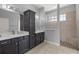 Bathroom featuring double vanity, modern fixtures, and glass block window over the shower at 10138 Lake Miona Way, Oxford, FL 34484